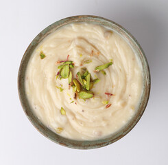 Shrikhand is an Indian sweet dish made of strained yogurt, garnished with dry fruits and saffron. 