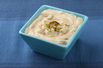 Shrikhand is an Indian sweet dish made of strained yogurt, garnished with dry fruits and saffron. 