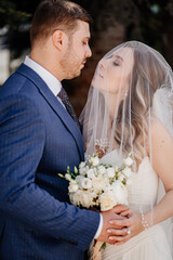 the gentle bride under the veil and groom. beautiful and romantic newlyweds. 