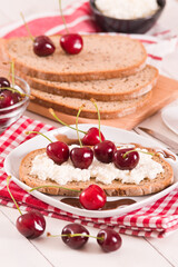Rye bread with cottage cheese and cherries.
