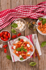 Fusilli pasta with cherry tomatoes and mozzarella cheese.