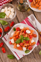 Fusilli pasta with cherry tomatoes and mozzarella cheese.