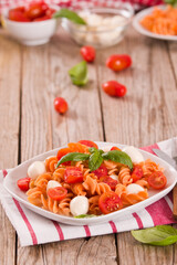 Fusilli pasta with cherry tomatoes and mozzarella cheese.
