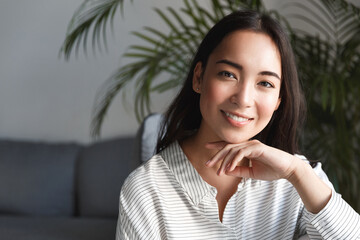 Close up of young asian business woman professional, smiling and looking happy confident at camera,...