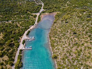 Aerial view of fishing boats moored near the pier on the island of Dugi Otok in front of the city of Zadar, Croatia. Vacation and tourism
