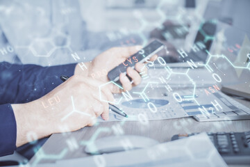 Fototapeta premium Double exposure of man's hands holding and using a phone and formulas drawing. Education concept.