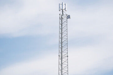 Obraz premium Telecommunication tower of 4G and 5G cellular. Cell Site Base Station. Wireless Communication Antenna Transmitter. Telecommunication tower with antennas against blue sky
