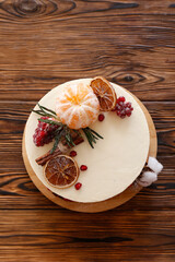 Minimalistic single tier wedding cake with white icing and decoration. Close up, copy space for text, background, top view.