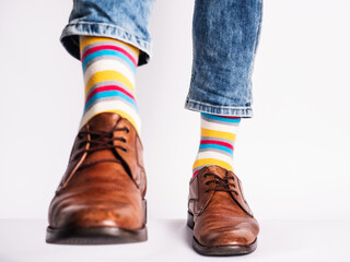 Men's legs, trendy shoes and bright socks. Close-up. Style, beauty and elegance concept