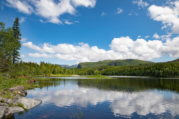 On a trip along Lake Strauman in Velfjord ,with blue sky and white ,Helgeland,Nordland county,scandinavia,Europe