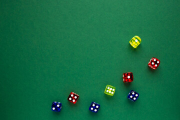 dice red and blue and yellow color green background