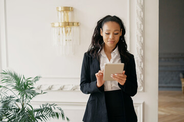 The accountant calculates the credit in the online table. Prints an email message to the client. Online distance learning via video link. Female manager smiles working in the office.