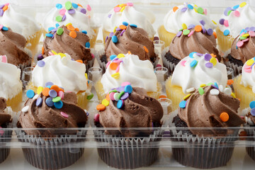 closeup mini chocolate and vanilla cupcakes - 440597314
