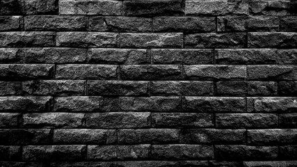 The black brick  walls were neatly stacked on top of each other. On a retro black background is suitable for a texture image and the background has space for text.
