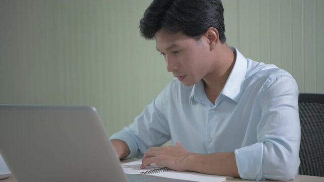 Business concept of 4k Resolution. An Asian man is delighted at his success at the office.