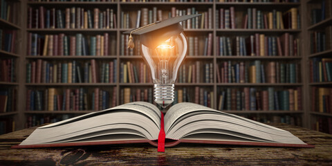 Education, knowledge and innovation concept background. Light bulb with mortar board on open book in vintage library.