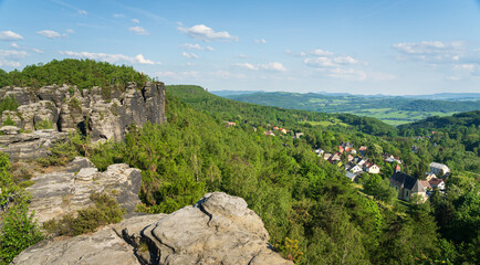 View of village Tisá next to sandstone rock formations in Tisá rocks, Czech republic. Film...