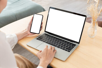 computer screen,cell phone blank mockup.hand woman work using laptop texting mobile.white background for advertising,contact business search information on desk in cafe.marketing,design