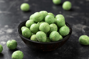 Spicy wasabi peanuts snack in black bowl