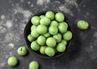 Spicy wasabi peanuts snack in black bowl
