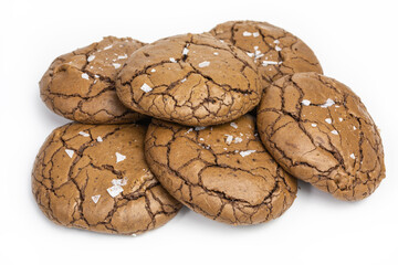 heap of chewy gluten-free chocolate cookies with flakes of sea salt