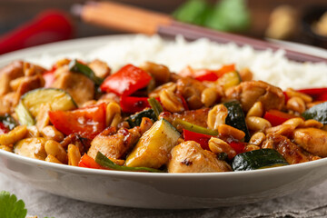 Kung Pao Chicken with Peppers, zucchini and rice. Asian take away food
