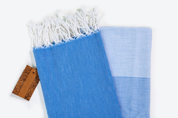 Blue Peshtemal Turkish towel folded colorful textile for spa, beach, pool, light travel, healthy fashion and gifts. Traditional turkish bath material