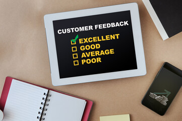 Customer feedback excellent good average and poor on computer digital tablet and stack of coins with arrow upwards trend on smartphone. Service rating satisfaction concept and five star review idea