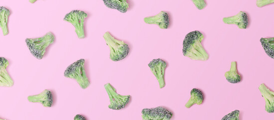 Deep frozen broccoli on a pink background. Top View