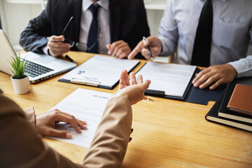 Examiner reading a resume during job interview at office