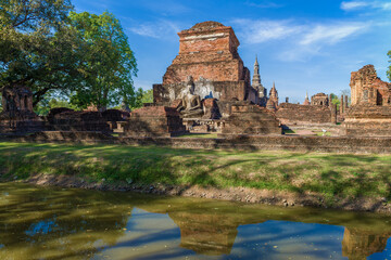 Fototapeta na wymiar Sunny day on the ancient ruins of the Buddhist temple of Wat Mahathat. Sukhothai, Thailand