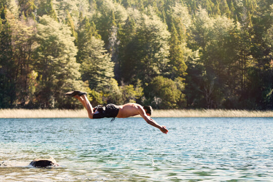 Man jumping at the lake in suumer