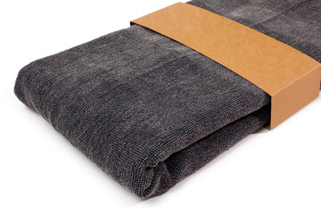 Black Peshtemal Turkish towel folded colorful textile for spa, beach, pool, light travel, healthy fashion and gifts. Traditional turkish bath material, stone print