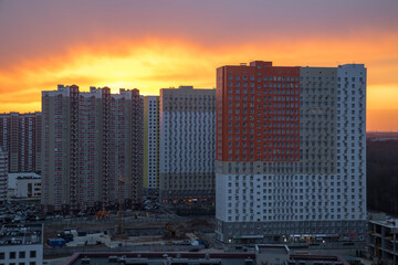 Beautiful and colorful sunset behind the houses in the city