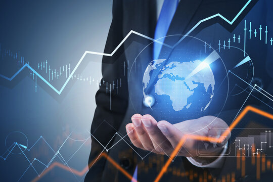 Financial graph showing increase of price in stock market, internet trading and Forex concept, businessman holding a hologram with digital globe on palm.