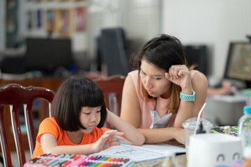 girl doing homework with mother, kid writing paper, education concept, back to school