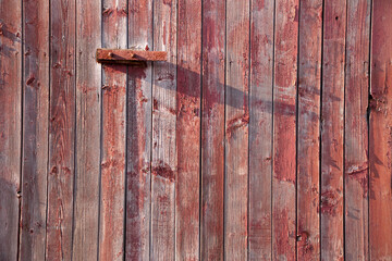 Weathered wood from the side of a red barn