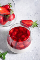 vegan panna cotta with strawberries and coconut milk on gray background. Healthy vegan dessert concept. vertical image. copy space
