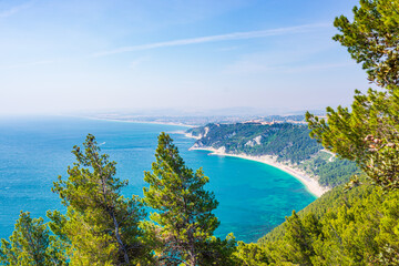 Obraz premium The beach of Mezzavalle view from above unique bay in Conero natural park dramatic coast headland rock cliff adriatic sea Italy turquoise transparent water