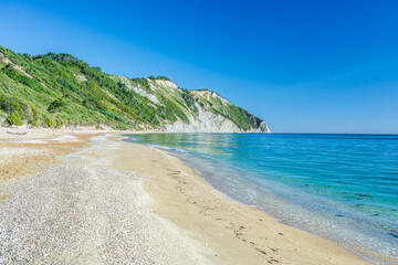 The beach of Mezzavalle view from above unique bay in Conero natural park dramatic coast headland rock cliff adriatic sea Italy turquoise transparent water
