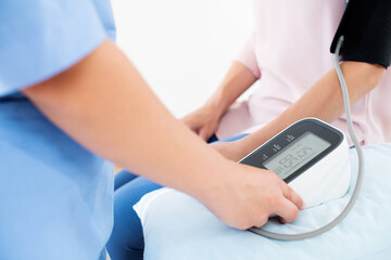 Young woman having her blood pressure checked by a nurse, doctor or a health visitor. Heart health....