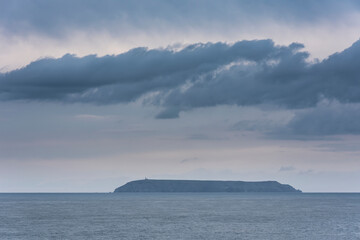 Fototapeta na wymiar Stunning fine art landscape image of view from Hartland Quay in Devon England durinbg moody Spring sunset