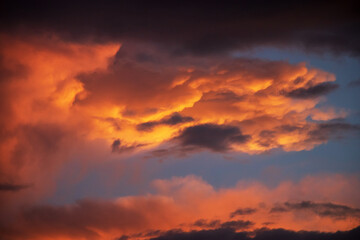 Sunset sky with amazing clouds shades of the orange, natural background.