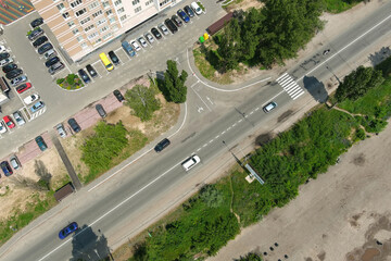 road near houses in the suburbs, with a small parking lot