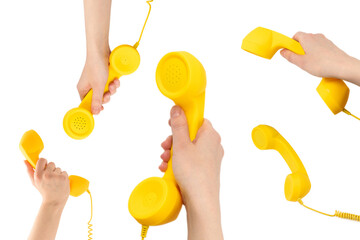 Yellow handset in woman hand isolated on white.
