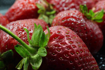 Defocus. Ripe, juicy red strawberry on a blurred berry background. Shallow focus