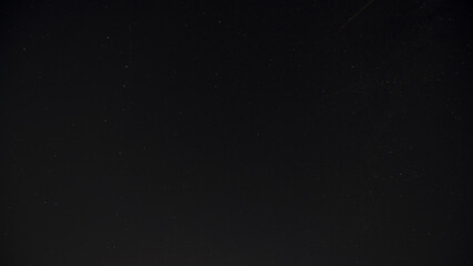night sky with stars and satellites