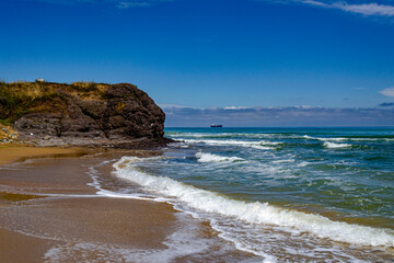 Beautiful sunny sand beach with waves