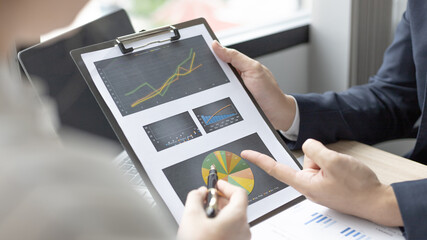 Brainstorm team, Marketers and financial accountants are discussing and analyzing charts to plan strategies to meet customer needs, Team meetings or business consulting.