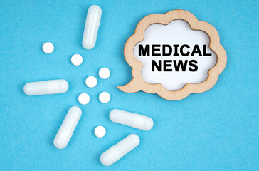 On a blue background, pills and a plate, inside which the inscription - MEDICAL NEWS